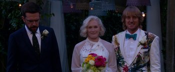Movie still from “Father Figures” (2017), directed by Lawrence Sher – A woman holding a bouquet of flowers in her hands; Medium shot, Over the shoulder angle