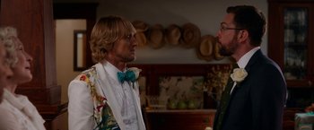 Movie still from “Father Figures” (2017), directed by Lawrence Sher – A man wearing a bow tie talking to another man; Medium shot, Over the shoulder angle