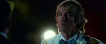 Movie still from “Father Figures” (2017), directed by Lawrence Sher – A person wearing a suit and a bow tie; Close Up shot, Over the shoulder angle