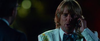 Movie still from “Father Figures” (2017), directed by Lawrence Sher – A person wearing a suit and tie; Close Up shot, Over the shoulder angle