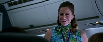 Movie still from “Father Figures” (2017), directed by Lawrence Sher – A woman in a blue and green dress smiling for the camera; Close Up shot, Over the shoulder angle