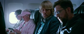 Movie still from “Father Figures” (2017), directed by Lawrence Sher – A group of people sitting on top of an airplane; Medium shot, Over the shoulder angle