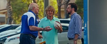 Movie still from “Father Figures” (2017), directed by Lawrence Sher – A group of men standing next to each other on a street; Medium shot, Over the shoulder angle