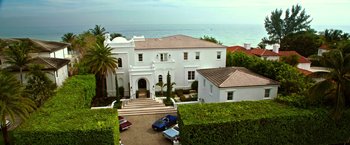 Movie still from “Father Figures” (2017), directed by Lawrence Sher – An aerial view of a large white house with ocean in the background; Extreme Wide shot, High angle