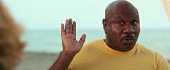 Movie still from “Father Figures” (2017), directed by Lawrence Sher – A person holding his hand up; Close Up shot, Low angle