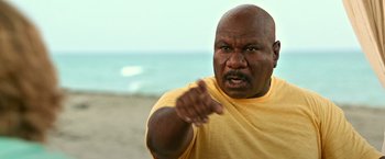 Movie still from “Father Figures” (2017), directed by Lawrence Sher – An angry man points at the camera on the beach; Close Up shot, High angle