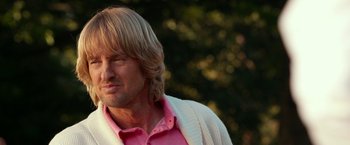Movie still from “Father Figures” (2017), directed by Lawrence Sher – A person wearing a pink shirt; Close Up shot, Over the shoulder angle