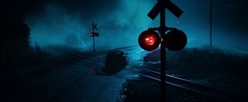 A car driving down a street next to a red light