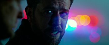 Movie still from “Father Figures” (2017), directed by Lawrence Sher – A man's face with lights in the background; Extreme Close Up shot, Over the shoulder angle