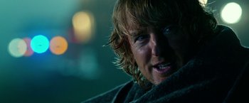 Movie still from “Father Figures” (2017), directed by Lawrence Sher – A man with long hair and blue eyes; Close Up shot, Over the shoulder angle