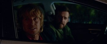 Movie still from “Father Figures” (2017), directed by Lawrence Sher – Two men sitting in the back seat of a car; Close Up shot, Over the shoulder angle