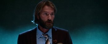 Movie still from “Father Figures” (2017), directed by Lawrence Sher – A man in a suit and tie looking to his left; Close Up shot, Low angle