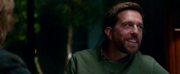 Movie still from “Father Figures” (2017), directed by Lawrence Sher – A person wearing a green shirt; Close Up shot, Over the shoulder angle