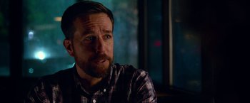 Movie still from “Father Figures” (2017), directed by Lawrence Sher – A person sitting in a room; Close Up shot, Over the shoulder angle