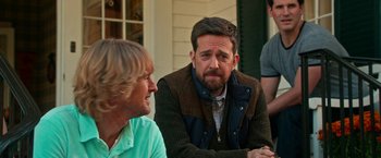 Movie still from “Father Figures” (2017), directed by Lawrence Sher – Two men sitting on a porch talking to each other; Medium shot, Over the shoulder angle