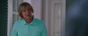 Movie still from “Father Figures” (2017), directed by Lawrence Sher – A person wearing a green polo shirt; Close Up shot, Over the shoulder angle