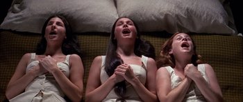 Movie still from “Fiddler on the Roof” (1971), directed by Norman Jewison – A group of women sitting on a couch with their mouths open; Medium shot, Overhead angle