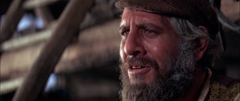 Movie still from “Fiddler on the Roof” (1971), directed by Norman Jewison – A man with a beard and a hat on; Close Up shot, Over the shoulder angle