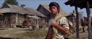 Movie still from “Fiddler on the Roof” (1971), directed by Norman Jewison – A man standing in front of an old barn; Medium shot, Low angle