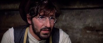 Movie still from “Fiddler on the Roof” (1971), directed by Norman Jewison – A person wearing glasses; Close Up shot, Over the shoulder angle
