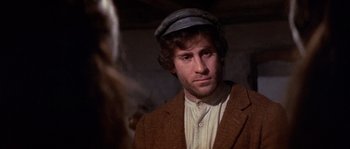 Movie still from “Fiddler on the Roof” (1971), directed by Norman Jewison – A man wearing a hat and a brown jacket; Close Up shot, Over the shoulder angle
