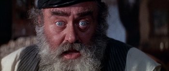 Movie still from “Fiddler on the Roof” (1971), directed by Norman Jewison – An old man with a beard and a hat; Close Up shot, Overhead angle