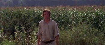 Movie still from “Fiddler on the Roof” (1971), directed by Norman Jewison – A man standing in front of a field of corn; Medium shot, Low angle