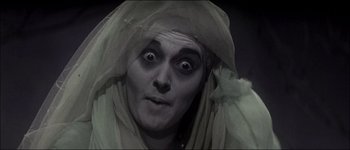 Movie still from “Fiddler on the Roof” (1971), directed by Norman Jewison – A man with a face covered by a veil; Close Up shot, Low angle