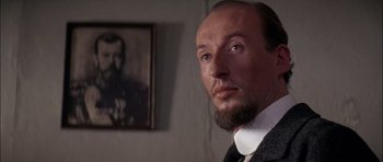 Movie still from “Fiddler on the Roof” (1971), directed by Norman Jewison – A person wearing a suit and tie; Close Up shot, Over the shoulder angle