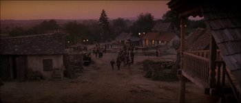Movie still from “Fiddler on the Roof” (1971), directed by Norman Jewison – People are walking through a dirt road at night; Extreme Wide shot, High angle