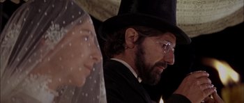 Movie still from “Fiddler on the Roof” (1971), directed by Norman Jewison – A man and a woman wearing a veil and wearing a hat; Close Up shot, Over the shoulder angle