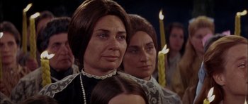 Movie still from “Fiddler on the Roof” (1971), directed by Norman Jewison – A woman and a girl are standing in front of candles; Close Up shot, Over the shoulder angle