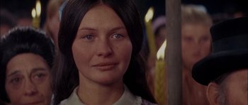 Movie still from “Fiddler on the Roof” (1971), directed by Norman Jewison – A person with a candle in the background; Close Up shot, Over the shoulder angle