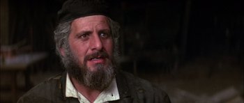 Movie still from “Fiddler on the Roof” (1971), directed by Norman Jewison – A man with a beard and a hat on; Close Up shot, Over the shoulder angle