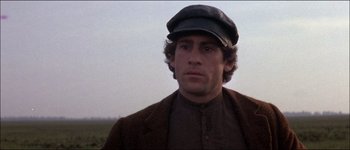Movie still from “Fiddler on the Roof” (1971), directed by Norman Jewison – A person wearing a hat and a jacket; Close Up shot, Low angle