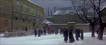 Movie still from “Fiddler on the Roof” (1971), directed by Norman Jewison – A group of people walking on a snowy street; Extreme Wide shot, High angle