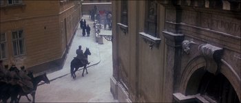 Movie still from “Fiddler on the Roof” (1971), directed by Norman Jewison – A man riding a horse down a street; Extreme Wide shot, High angle