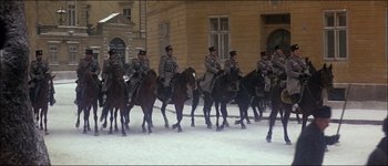 Movie still from “Fiddler on the Roof” (1971), directed by Norman Jewison – A group of men riding on the backs of horses; Wide shot, High angle
