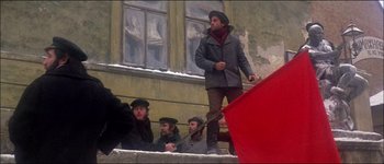 Movie still from “Fiddler on the Roof” (1971), directed by Norman Jewison – A group of men standing next to each other on steps; Wide shot, Low angle