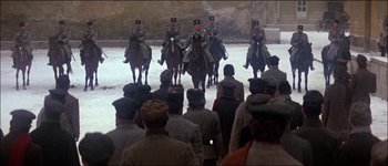 Movie still from “Fiddler on the Roof” (1971), directed by Norman Jewison – A group of men on horseback riding across a body of water; Wide shot, High angle