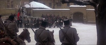 Movie still from “Fiddler on the Roof” (1971), directed by Norman Jewison – A group of men in uniform standing in the snow; Wide shot, High angle