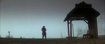 Movie still from “Fiddler on the Roof” (1971), directed by Norman Jewison – A man standing in the middle of a dirt field; Extreme Wide shot, Low angle