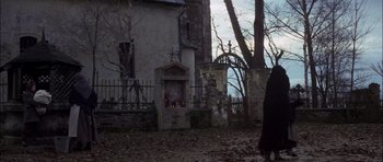 Movie still from “Fiddler on the Roof” (1971), directed by Norman Jewison – A person standing in front of an old building; Wide shot, Low angle