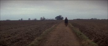 Movie still from “Fiddler on the Roof” (1971), directed by Norman Jewison – A woman is walking down a dirt road; Extreme Wide shot, High angle