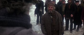 Movie still from “Fiddler on the Roof” (1971), directed by Norman Jewison – A group of people standing in the middle of a snowy field; Medium shot, Over the shoulder angle
