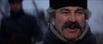 Movie still from “Fiddler on the Roof” (1971), directed by Norman Jewison – An older man wearing a hat and a scarf; Close Up shot, Low angle