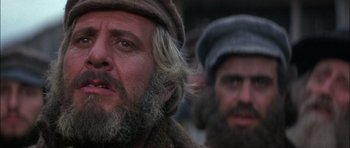 Movie still from “Fiddler on the Roof” (1971), directed by Norman Jewison – A man with long hair and a beard wearing a hat; Close Up shot, Low angle
