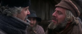 Movie still from “Fiddler on the Roof” (1971), directed by Norman Jewison – A group of men standing next to each other; Close Up shot, Over the shoulder angle