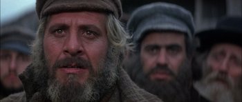 Movie still from “Fiddler on the Roof” (1971), directed by Norman Jewison – A man with a long beard and a hat on; Close Up shot, Low angle