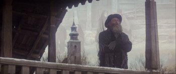 Movie still from “Fiddler on the Roof” (1971), directed by Norman Jewison – An old man with a long beard standing in the snow; Wide shot, Low angle